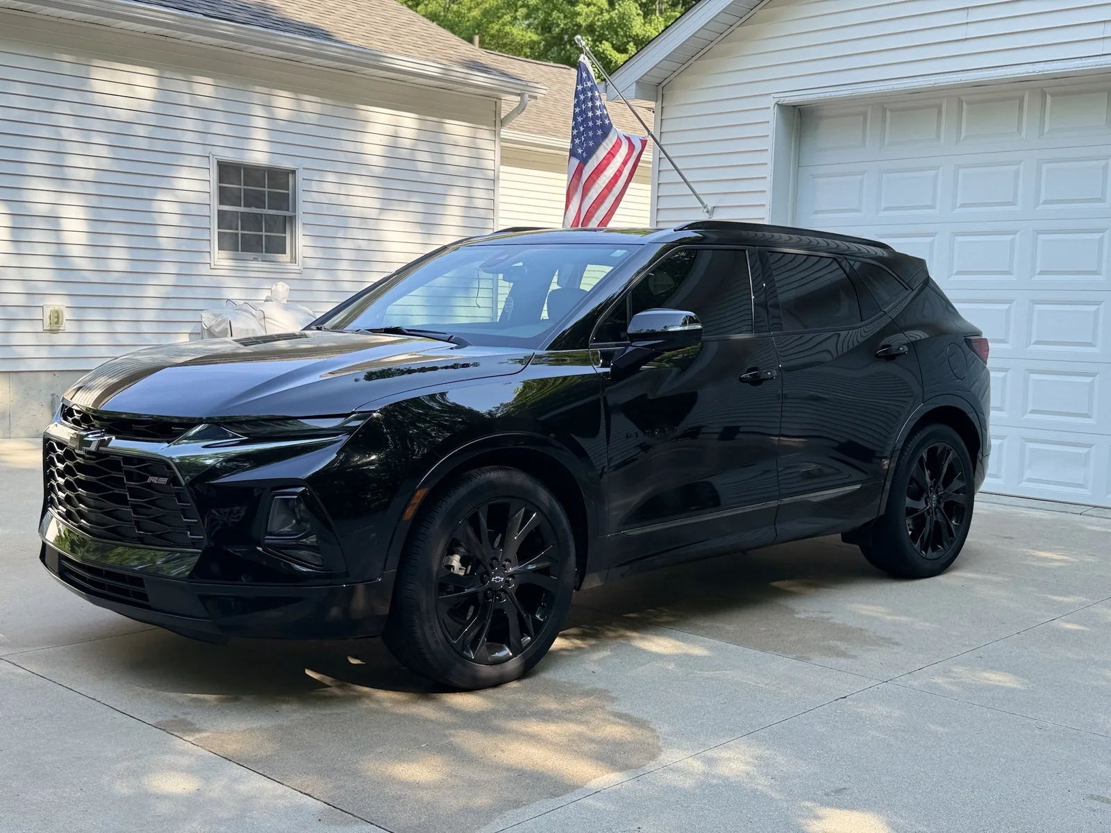 Black Chevy Blazer RS with glossy paint after a driveway detail