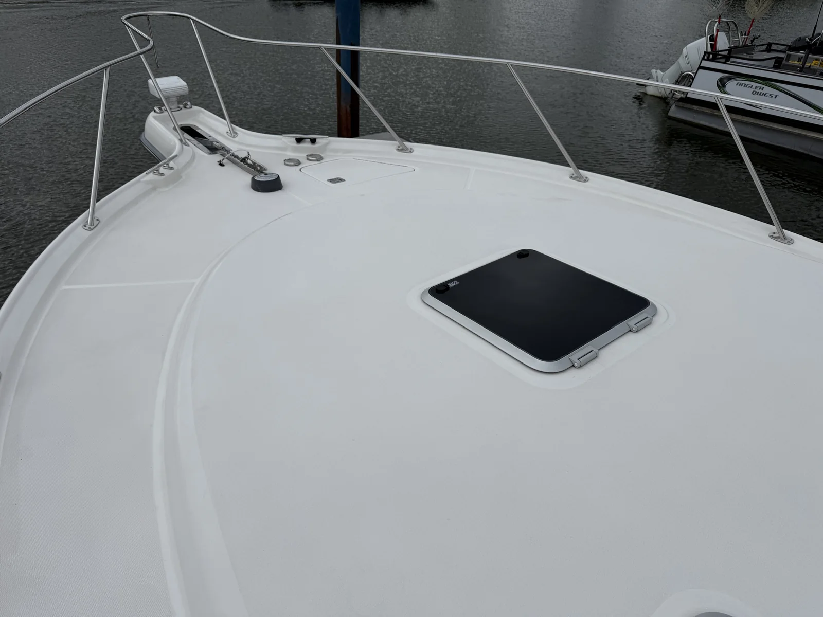 Clean white boat bow deck and hatch after an on-deck cleaning
