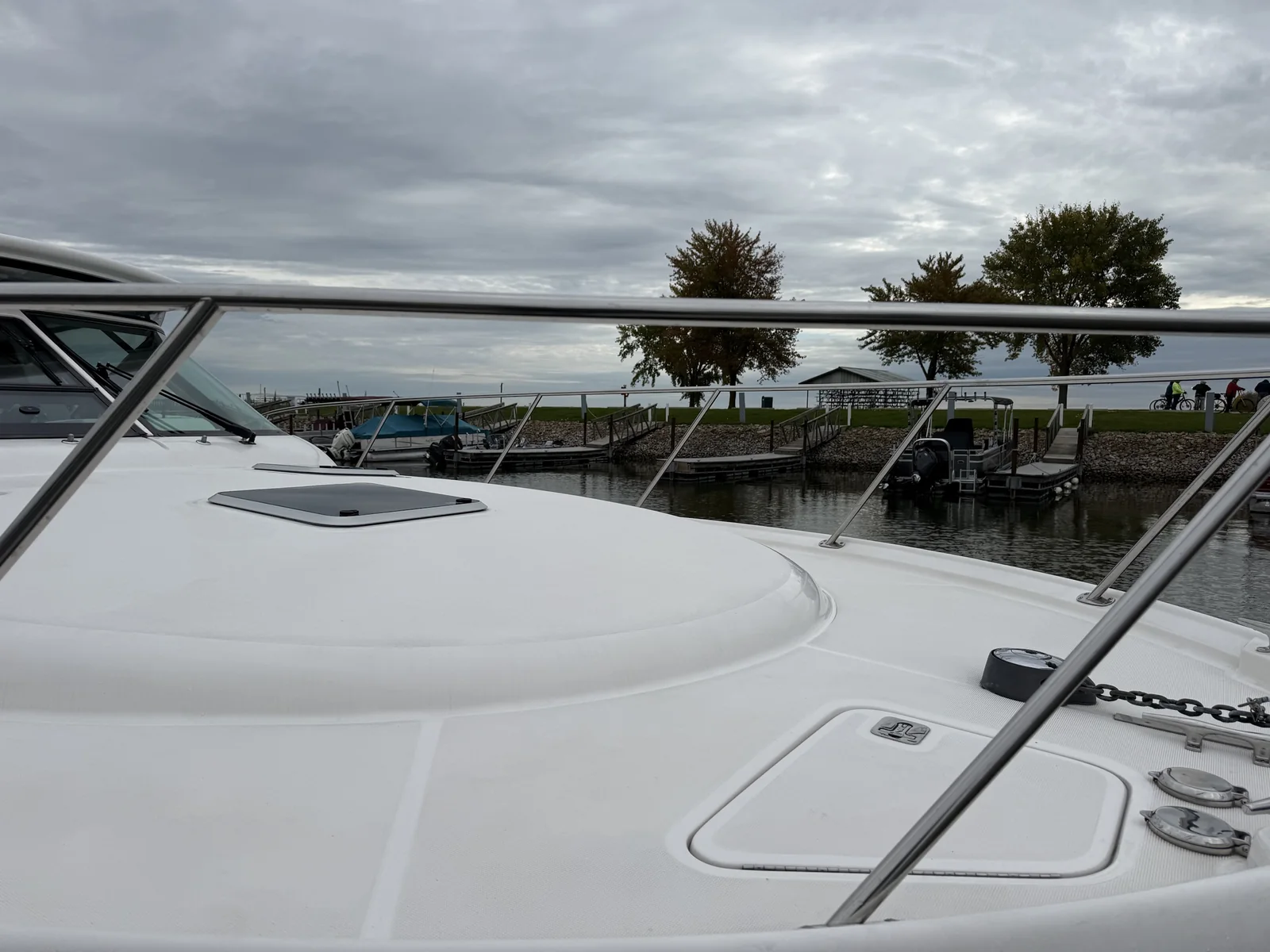 White cruiser bow deck and stainless rails after boat detailing at the marina