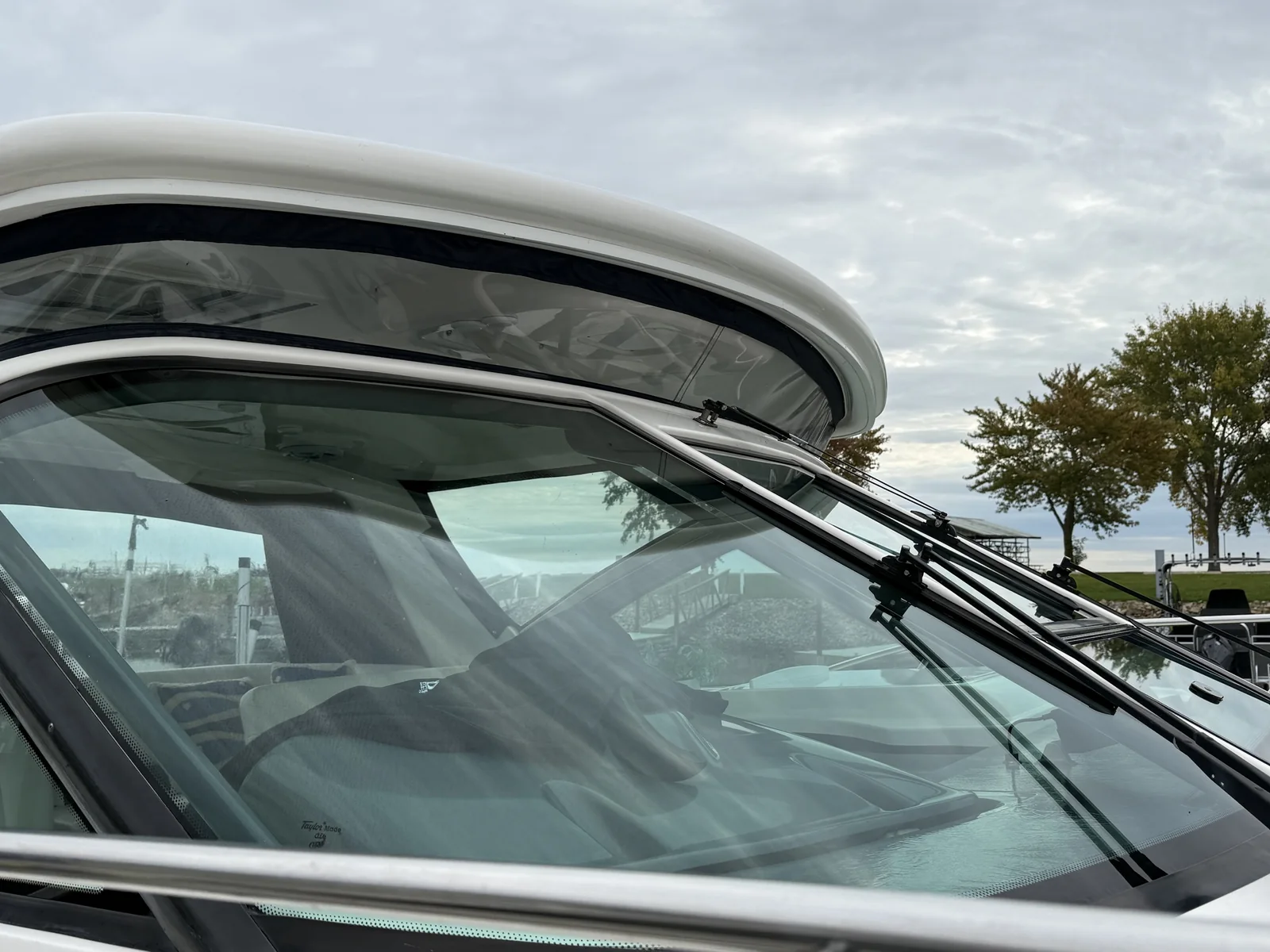 Clean boat windshield and hardtop after marine detailing at the marina