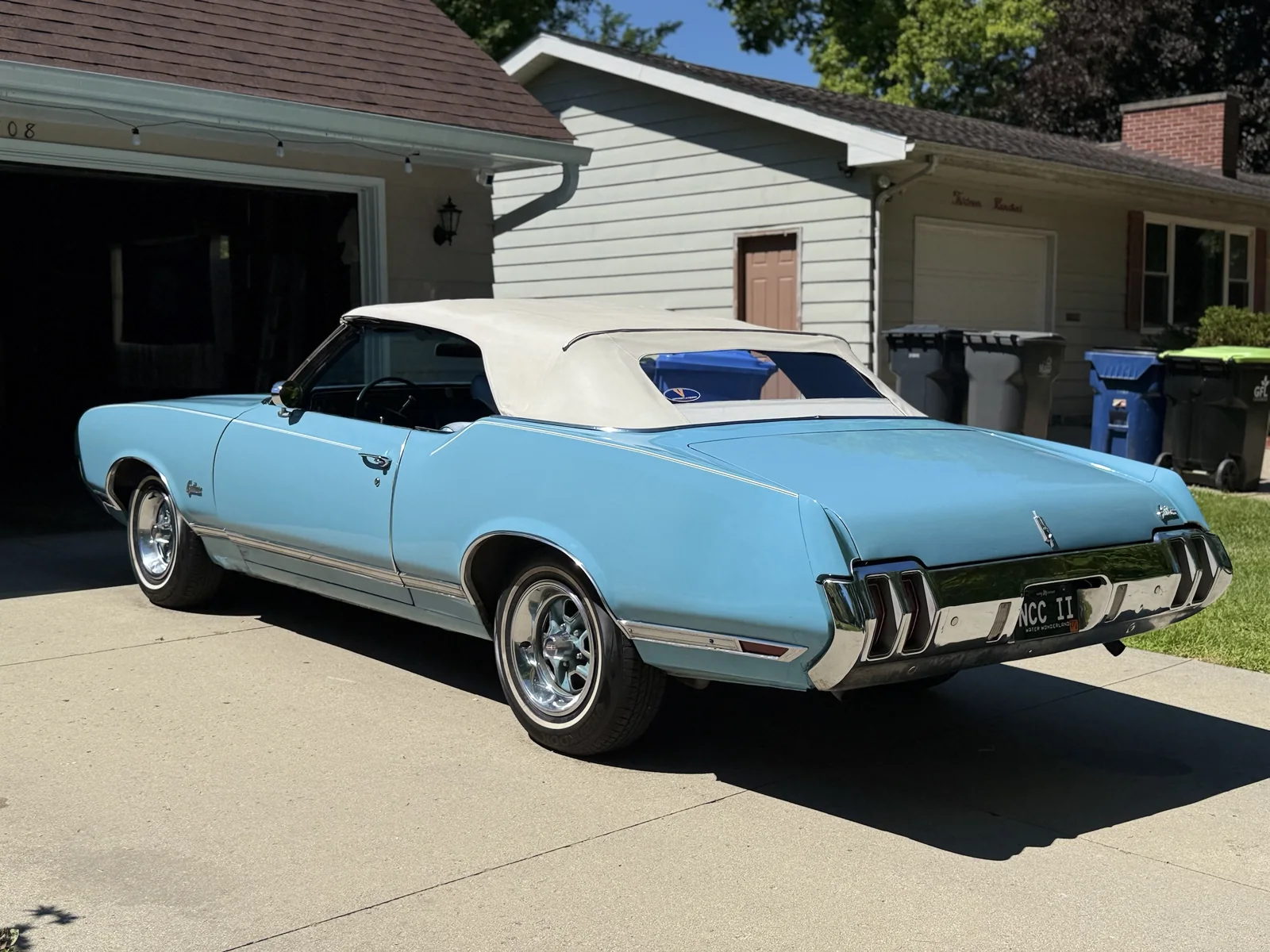 Light blue classic Oldsmobile Cutlass convertible after a mobile detail