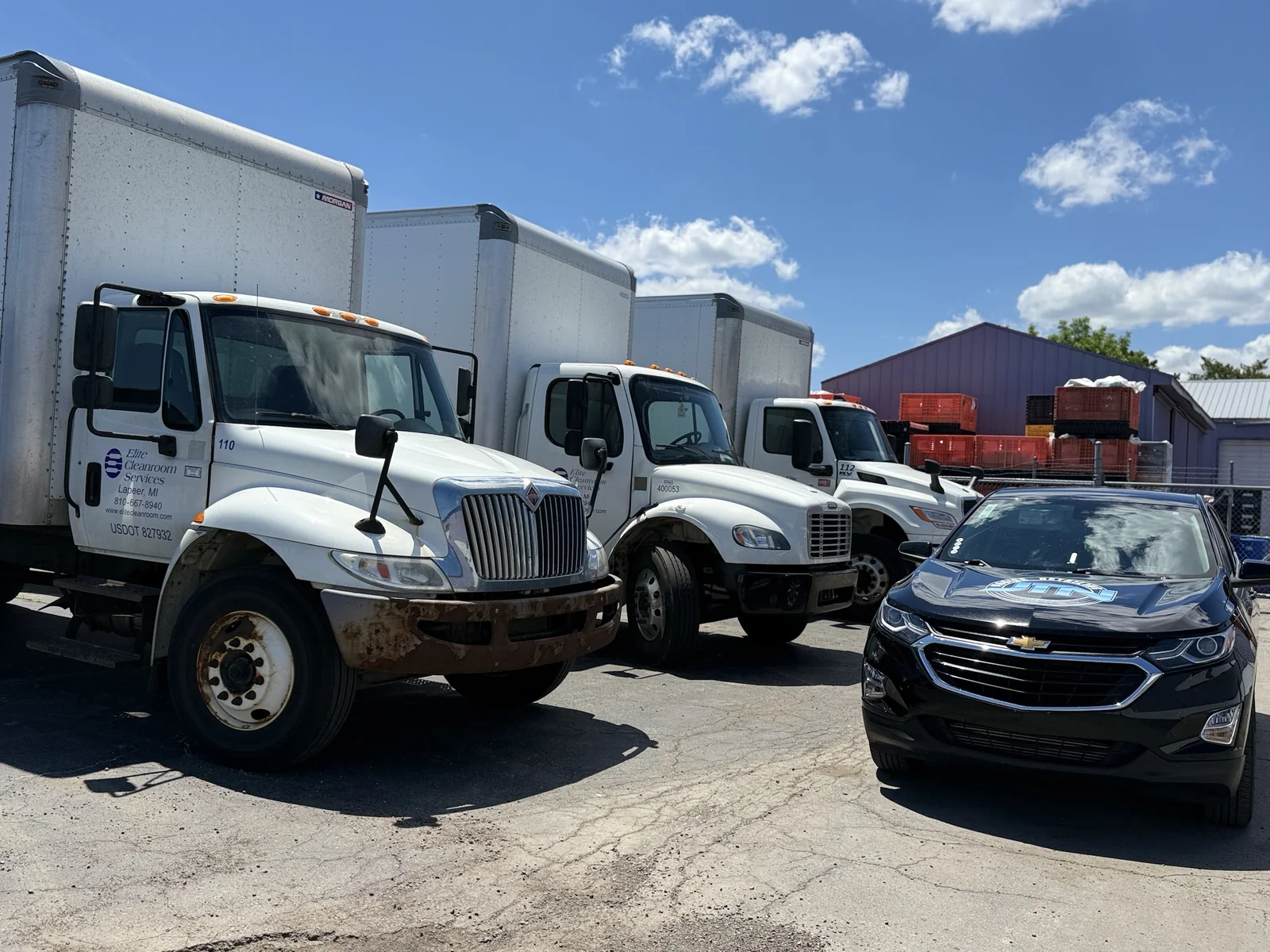 Fleet box trucks at a business lot with a JTN Mobile Detailing unit on site