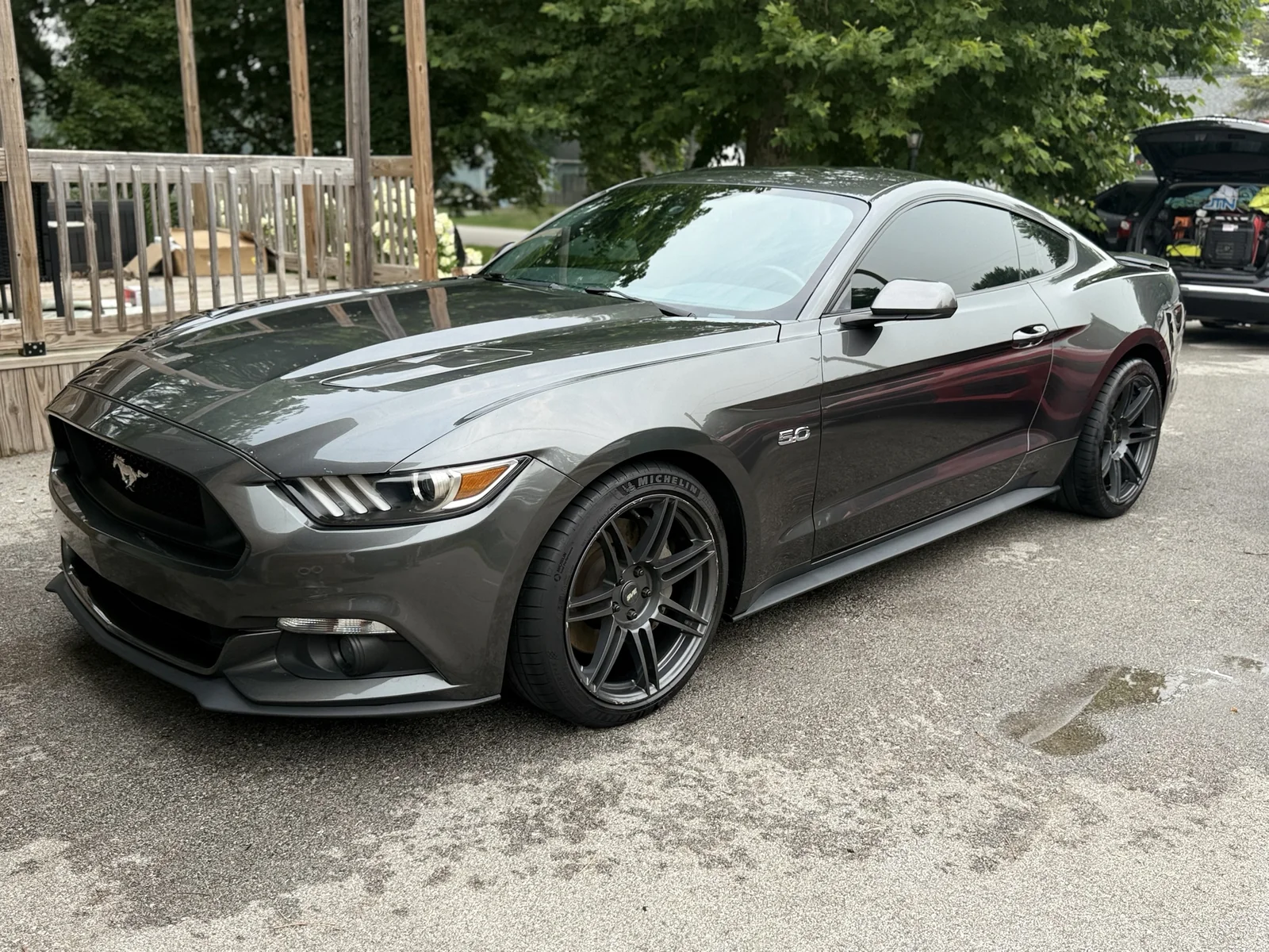 Gray Ford Mustang GT after a mobile detail, with a JTN unit's open hatch in the background