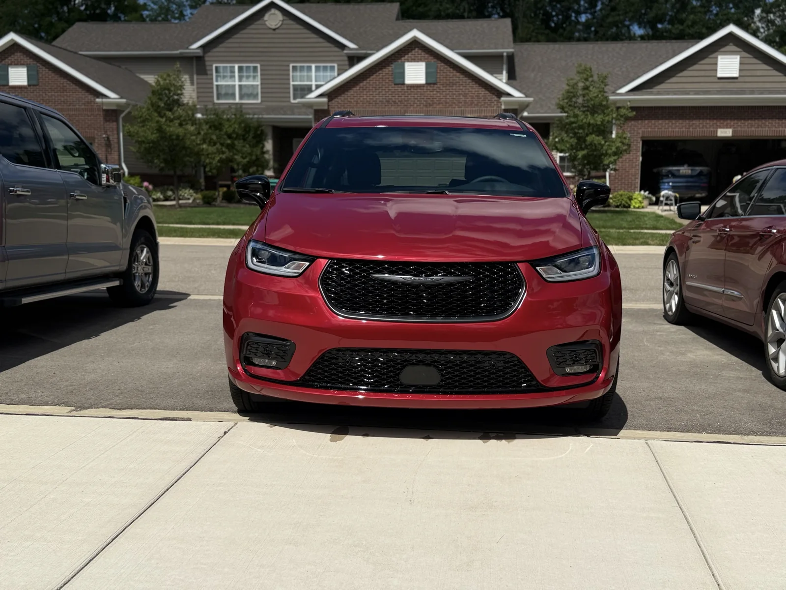 Red Chrysler Pacifica minivan with glossy paint after detailing