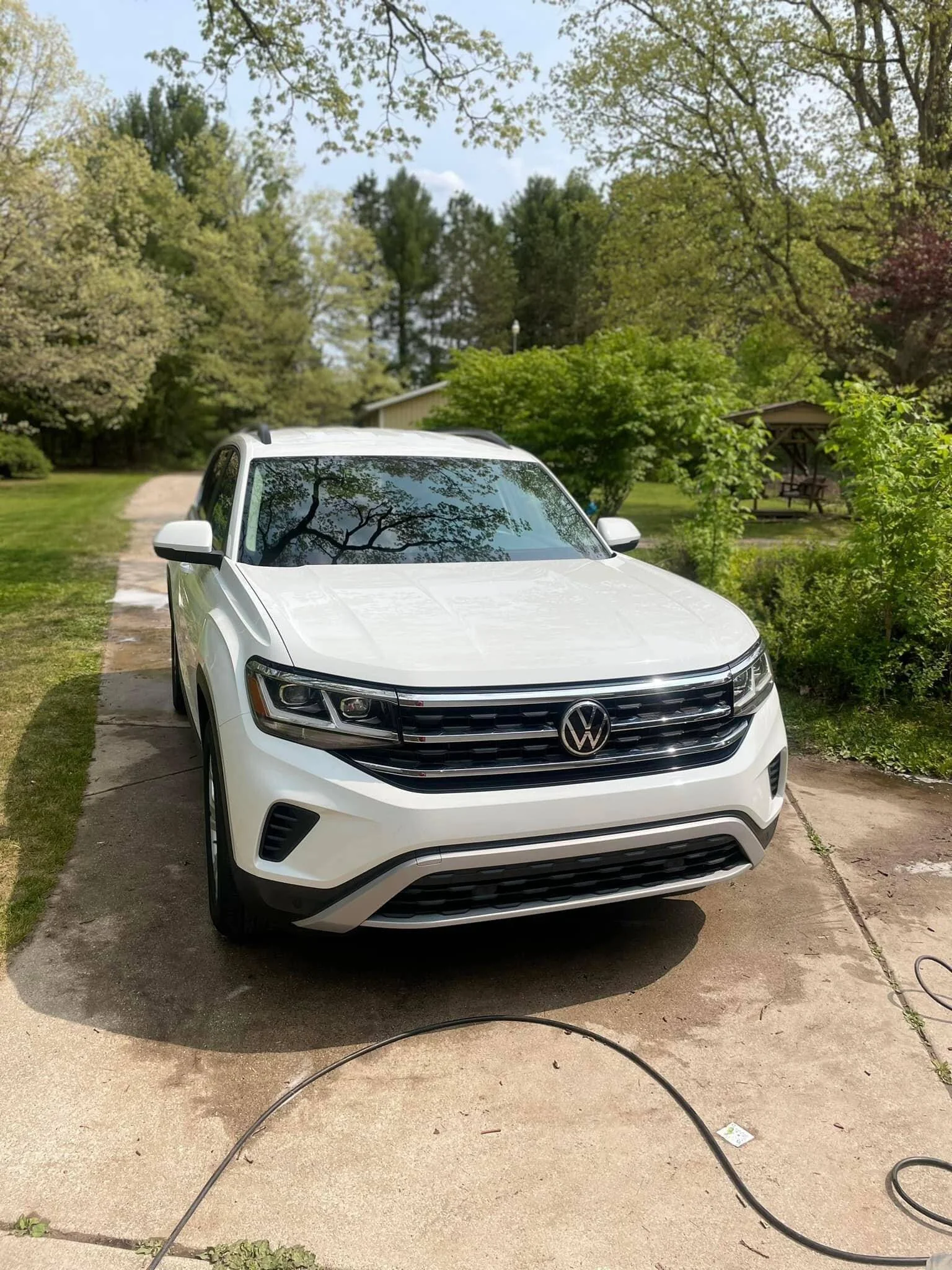 White Volkswagen Atlas washed in a customer's driveway during a mobile detail