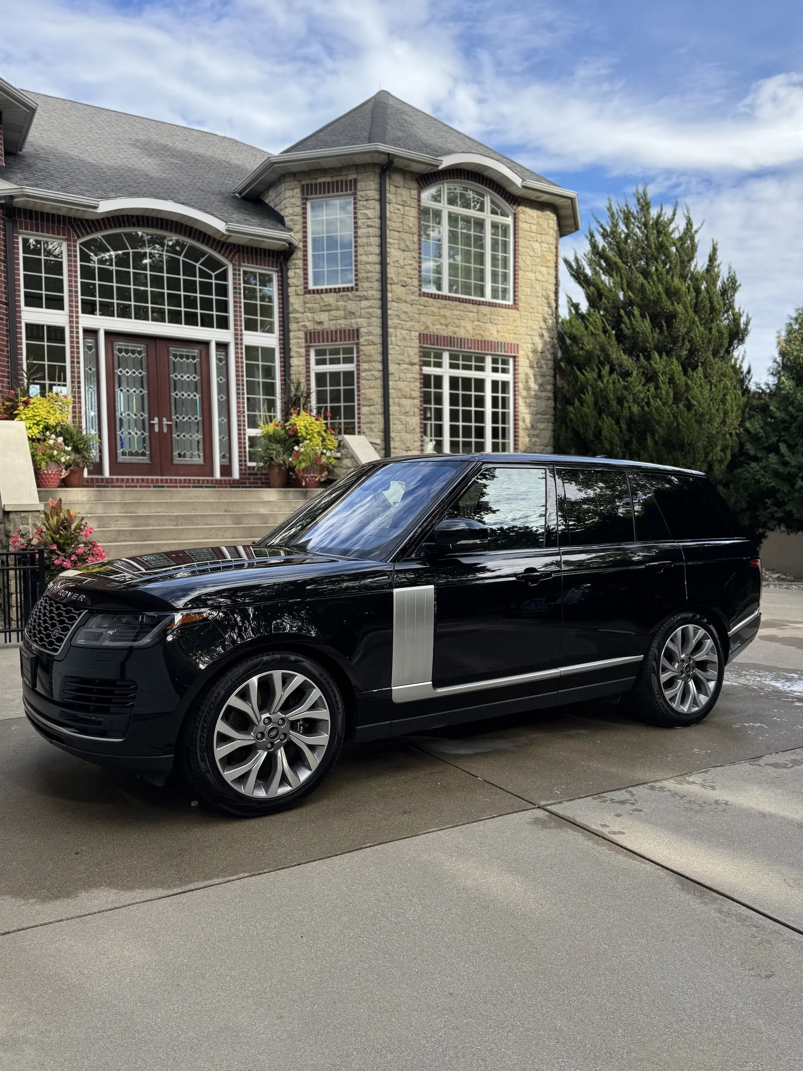 Black Range Rover with glossy paint after a mobile detail in a home driveway