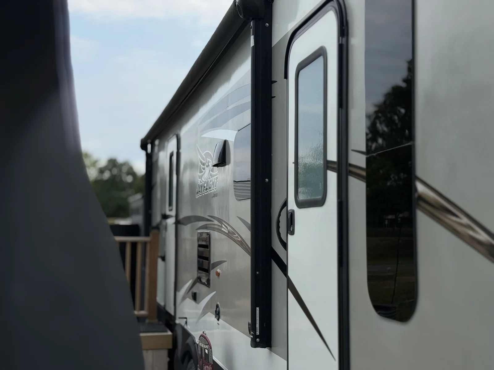 Clean, reflective camper sidewall and door after RV washing and detailing